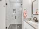 Elegant bathroom features marble tile shower with black framed glass and granite countertop at 399 Chestnut St, Social Circle, GA 30025