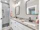 Bright bathroom features double sinks, granite countertops, and glass-enclosed shower at 399 Chestnut St, Social Circle, GA 30025