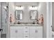 Stylish bathroom with double vanity, granite countertops, and glass-enclosed shower at 399 Chestnut St, Social Circle, GA 30025
