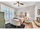Cozy bedroom with hardwood floors, white shutters, and ornate furnishings for a luxurious feel at 399 Chestnut St, Social Circle, GA 30025