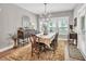 Elegant dining room features traditional furnishings, chandelier lighting, and plenty of natural light at 399 Chestnut St, Social Circle, GA 30025