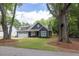 Charming home with a well-maintained lawn, a classic design, and mature trees gracing the front yard at 399 Chestnut St, Social Circle, GA 30025