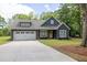 Inviting curb appeal with a well-manicured lawn, covered front porch, and a bright yellow front door at 399 Chestnut St, Social Circle, GA 30025