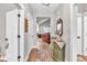 Hallway with hardwood floors leads to the home's living area, decorated with neutral tones and stylish accents at 399 Chestnut St, Social Circle, GA 30025