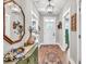 Hallway with hardwood floors leads to the home's entry, decorated with neutral tones and stylish accents at 399 Chestnut St, Social Circle, GA 30025
