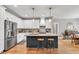 Bright kitchen boasts stainless steel appliances, granite countertops, and a convenient island with seating at 399 Chestnut St, Social Circle, GA 30025
