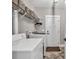 Functional laundry room equipped with modern washer and dryer units and ample shelving for storage at 399 Chestnut St, Social Circle, GA 30025