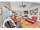 Inviting living room with a vaulted ceiling, a cozy fireplace, and ample seating at 399 Chestnut St, Social Circle, GA 30025