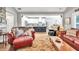 Inviting living room open to kitchen, featuring stylish furnishings and hardwood floors at 399 Chestnut St, Social Circle, GA 30025