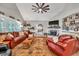 Bright living room with vaulted ceiling, fireplace, plantation shutters, and comfortable seating arrangement at 399 Chestnut St, Social Circle, GA 30025