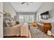 Comfortable main bedroom with neutral colors, ceiling fan, and large dresser at 399 Chestnut St, Social Circle, GA 30025