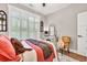 Bright main bedroom features lots of natural light, ceiling fan, and wood floors at 399 Chestnut St, Social Circle, GA 30025