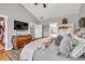 Spacious main bedroom with walk-in closet, ensuite bathroom, and large dresser with mounted TV at 399 Chestnut St, Social Circle, GA 30025