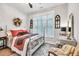 Comfortable main bedroom with white wood trim on windows and wood floors at 399 Chestnut St, Social Circle, GA 30025