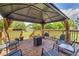 Covered deck with outdoor seating and fire pit overlooking a spacious backyard at 3135 Castlewood Dr, Loganville, GA 30052
