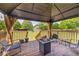 Covered deck with outdoor seating and fire pit overlooking a backyard at 3135 Castlewood Dr, Loganville, GA 30052