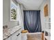 A bathroom that has a granite sink, a shower with a curtain, and a toilet with a wood seat at 3135 Castlewood Dr, Loganville, GA 30052