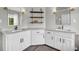 Bright bathroom with double sinks, white cabinetry, and sleek black hardware accents at 3135 Castlewood Dr, Loganville, GA 30052