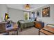 This bedroom features neutral walls, a window view of a treed area, a desk, and unique decorations at 3135 Castlewood Dr, Loganville, GA 30052