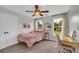 Bright bedroom with two windows, a double bed, and a desk near the window at 3135 Castlewood Dr, Loganville, GA 30052