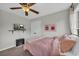 Cozy bedroom with ceiling fan, TV, and charming decor at 3135 Castlewood Dr, Loganville, GA 30052