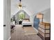 Bright bedroom with sloped ceiling, a ceiling fan and a large window at 3135 Castlewood Dr, Loganville, GA 30052