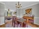 Open-concept dining area connects to a cozy living room and features hardwood floors and a wooden table and chairs at 3135 Castlewood Dr, Loganville, GA 30052