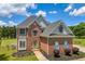 Beautiful two-story brick home with large windows and lush green lawn at 3135 Castlewood Dr, Loganville, GA 30052