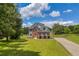 Beautiful two-story brick home with a manicured lawn and professional landscaping at 3135 Castlewood Dr, Loganville, GA 30052