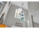 Stunning two-story foyer with a decorative chandelier and large window that adds architectural interest at 3135 Castlewood Dr, Loganville, GA 30052