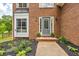 Charming brick home featuring a welcoming front entrance with a decorative door and manicured landscaping at 3135 Castlewood Dr, Loganville, GA 30052