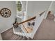 Hallway with stairs featuring natural light, chandelier, and wood banister at 3135 Castlewood Dr, Loganville, GA 30052