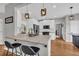 A kitchen with white cabinets, stainless steel appliances, granite countertops, and wooden floors at 3135 Castlewood Dr, Loganville, GA 30052