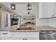Modern kitchen featuring granite countertops, stainless steel appliances, and an open layout flowing to the living space at 3135 Castlewood Dr, Loganville, GA 30052