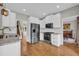 Bright kitchen with stainless steel appliances, white cabinets, and a view to the staircase and dining area at 3135 Castlewood Dr, Loganville, GA 30052