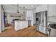 Well-lit kitchen features white cabinets, stainless steel appliances, and a view into a cozy living room at 3135 Castlewood Dr, Loganville, GA 30052