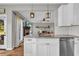 Kitchen featuring white cabinets, stainless steel appliances, granite countertops, and tile backsplash at 3135 Castlewood Dr, Loganville, GA 30052