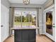 Kitchen island with seating in a kitchen with white cabinets, granite countertops, and hardwood floors at 3135 Castlewood Dr, Loganville, GA 30052