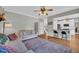 Bright living room with hardwood floors, comfortable seating, and an open layout connecting to the kitchen at 3135 Castlewood Dr, Loganville, GA 30052