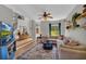 Cozy living room with a TV, staircase, and hardwood floors, along with an inviting seating area near a bright window at 3135 Castlewood Dr, Loganville, GA 30052