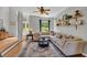 Comfortable living room features a large sectional couch, area rug, and modern decor with natural light from the windows at 3135 Castlewood Dr, Loganville, GA 30052