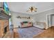 Cozy living room with a brick fireplace, hardwood floors, and two comfortable couches for relaxing or entertaining at 3135 Castlewood Dr, Loganville, GA 30052