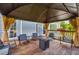 Inviting outdoor space with a covered patio, comfortable seating, and a cozy fire pit for relaxing evenings at 3135 Castlewood Dr, Loganville, GA 30052