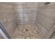 Beautiful shower with light stone-look tiling and glass door at 3135 Castlewood Dr, Loganville, GA 30052