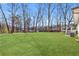Expansive green backyard with a lake view, a play set, mature trees, and a well-maintained lawn at 4304 Lake Laurel Se Dr, Smyrna, GA 30082