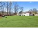Large, green backyard featuring a play set, wooded area, well-kept lawn and the rear of the home at 4304 Lake Laurel Se Dr, Smyrna, GA 30082