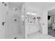 Bathroom with a glass shower, double sink vanity, herringbone floor, and a glimpse into the bedroom at 4304 Lake Laurel Se Dr, Smyrna, GA 30082