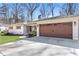 Inviting home featuring a spacious driveway leading to an attached garage with a meticulously maintained lawn at 4304 Lake Laurel Se Dr, Smyrna, GA 30082
