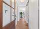 Bright entryway featuring hardwood floors, a glass-paneled door, and a modern coat rack and decor at 4304 Lake Laurel Se Dr, Smyrna, GA 30082