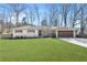 Charming, renovated single-story home featuring a lush green lawn, attached garage, and a welcoming front entrance at 4304 Lake Laurel Se Dr, Smyrna, GA 30082